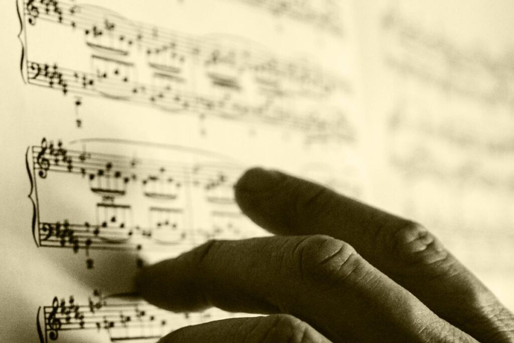 Notes in music - A hand on the musical piece